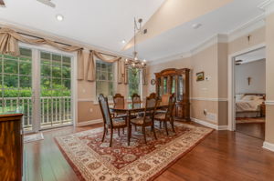 Dining Room A full wall of windows & sliding doors fill the space w natural light & open to a private balcony overlooking a peaceful wooded setting.