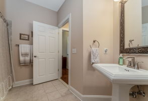 Full Hall Bath The hall bath features a pedestal sink, tub-shower in tile surround and ceramic tile floor.
