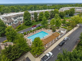 Aerial View of Amenities The meticulously maintained grounds, with colorful Zen-like gardens and a tranquil water-fall fountain creates a peaceful setting for relaxation and socializing.