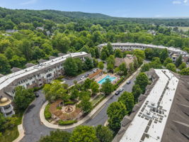 Aerial View of Amenities The meticulously maintained grounds, with colorful Zen-like gardens and a tranquil water-fall fountain creates a peaceful setting for relaxation and socializing.