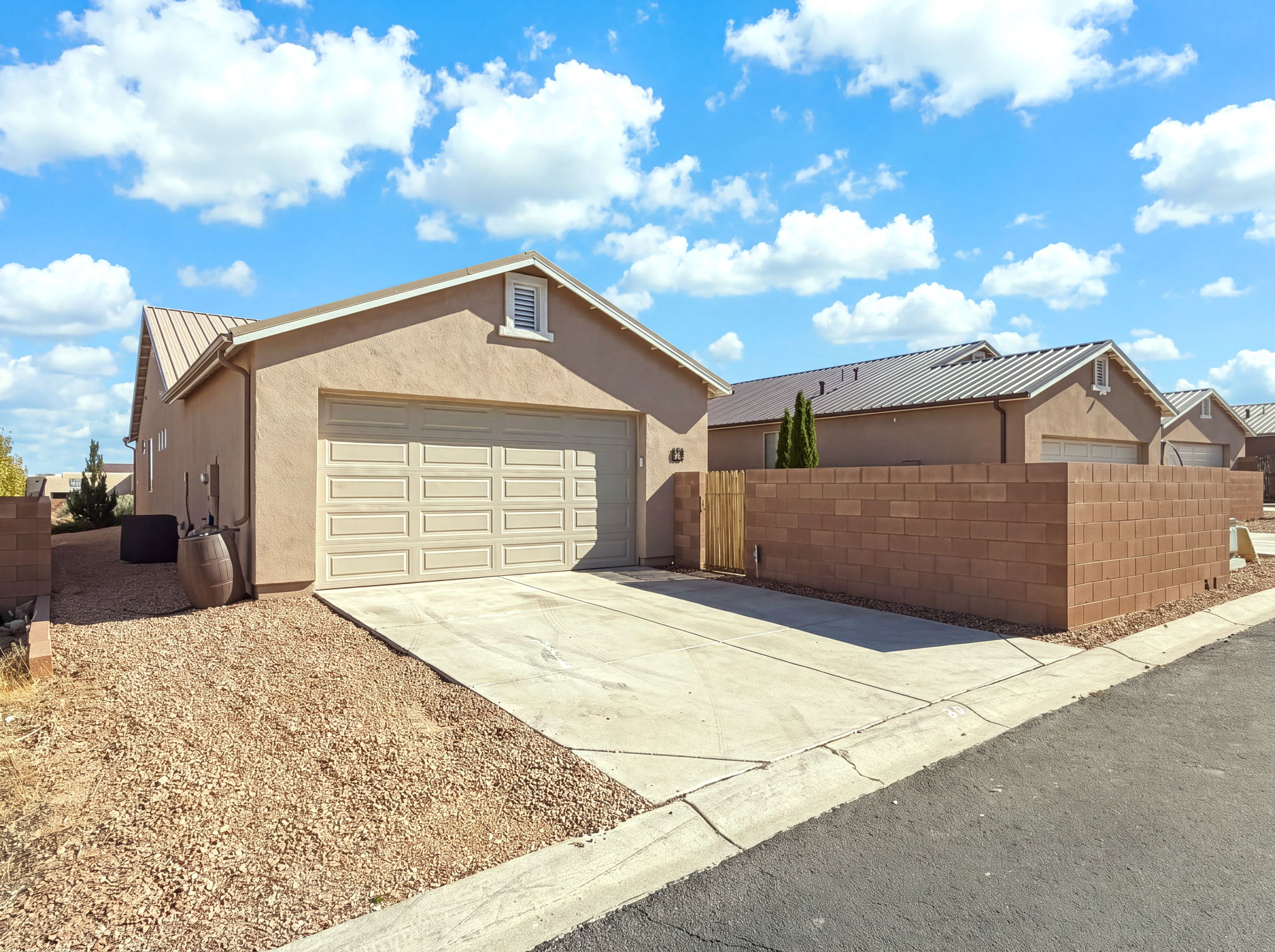 Rear entry Garage with rain barrel