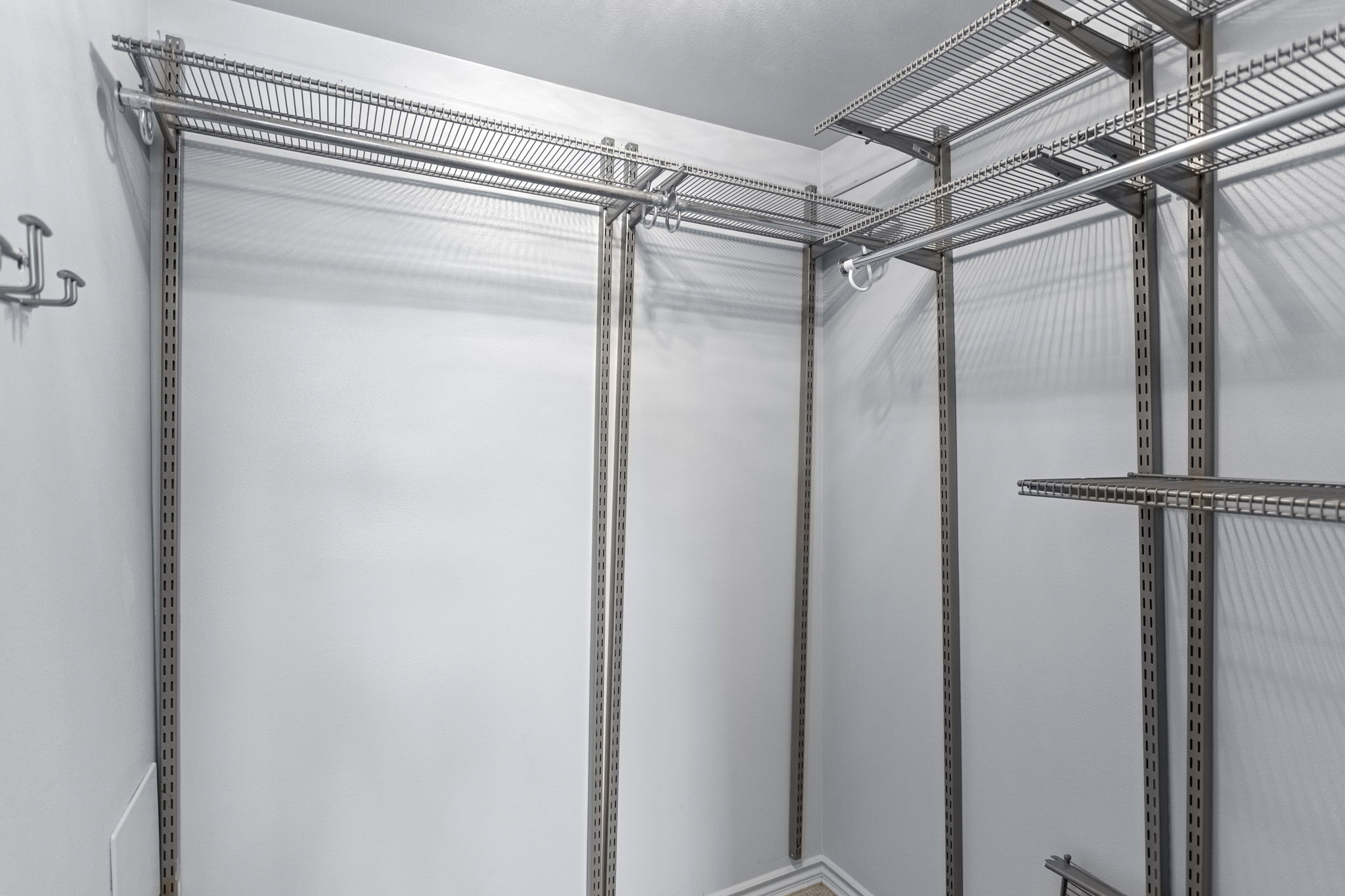 A true walk-in closet adds substantial hanging and shelf storage to the main-level bedroom.