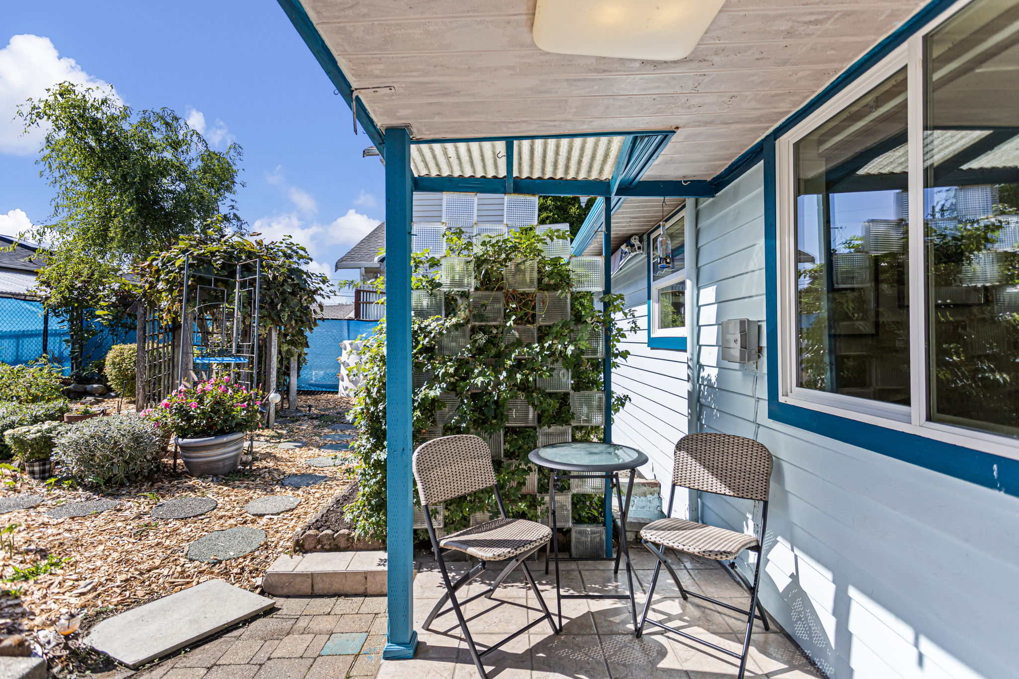 Just off the kitchen, a covered patio creates a sheltered spot to sit with the sunny south-facing garden stretching out beside it.