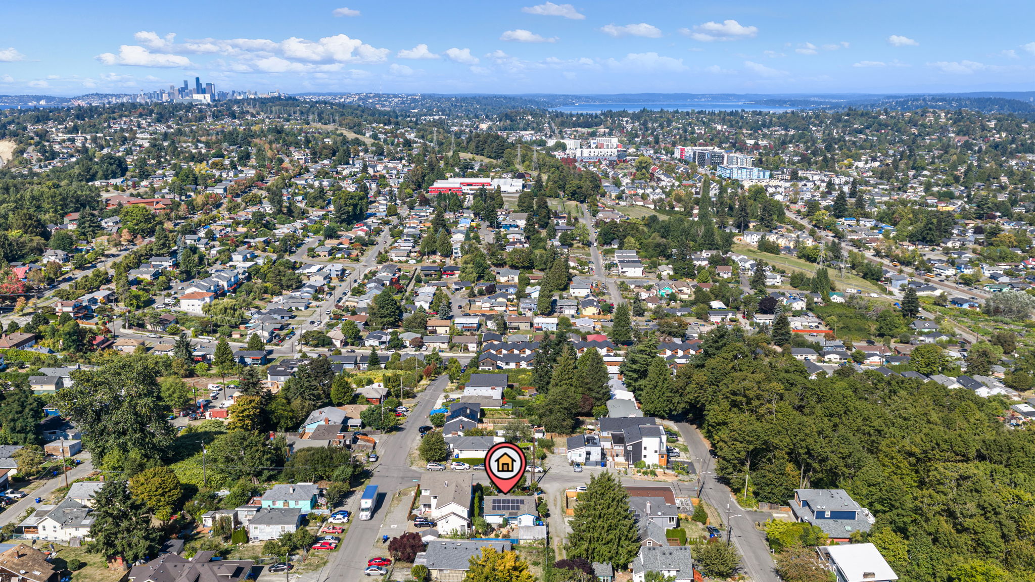 A wider neighborhood aerial places the home in South Beacon Hill, with downtown Seattle visible across the cityscape. Subject location marked for context.
