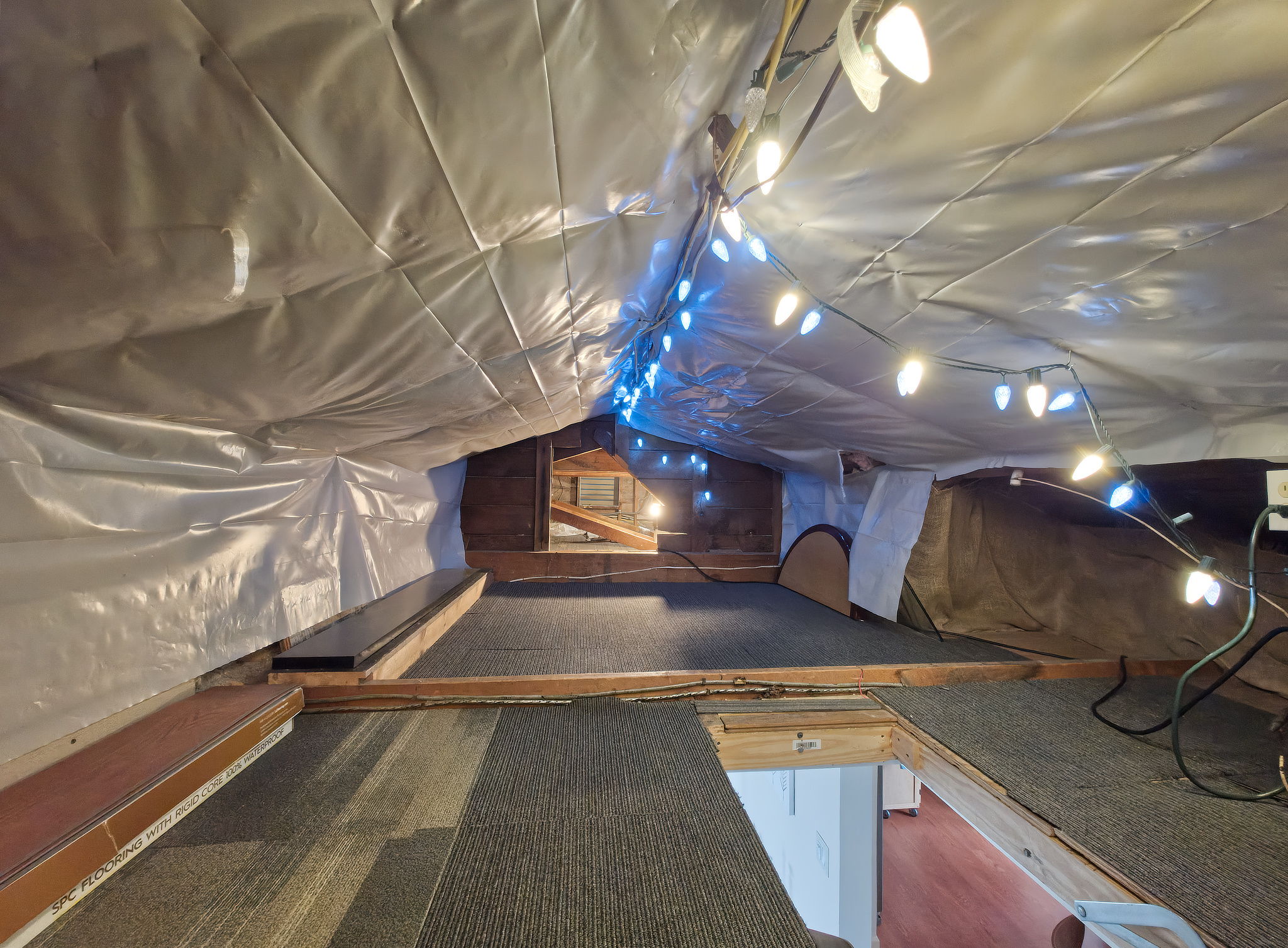 A pull-down ceiling hatch with folding ladder makes the attic storage easy to access and practical for regular use.