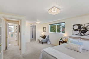 The reverse angle shows the bedroom’s walk-in closet and full bath just beyond—useful storage and everyday function gathered together on the main level.