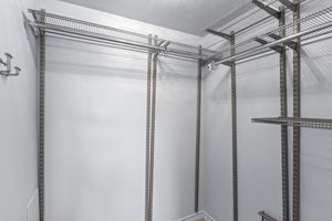 A true walk-in closet adds substantial hanging and shelf storage to the main-level bedroom.