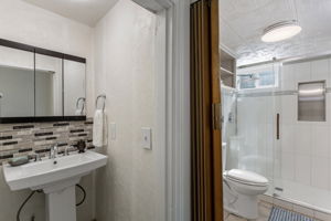 The 3/4 bath is cleverly split into two spaces, with the pedestal sink separate from the roomy glass-enclosed shower and toilet area.