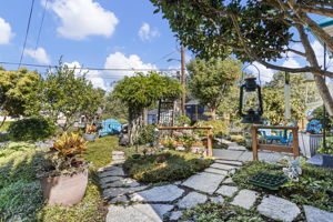 Collected, not landscaped by formula: winding slate paths, sculpted plantings, garden art and a tucked-away seating area.