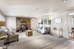 Generous main-level living room with a stone fireplace, working pellet stove and ductless mini-split for heating and A/C.