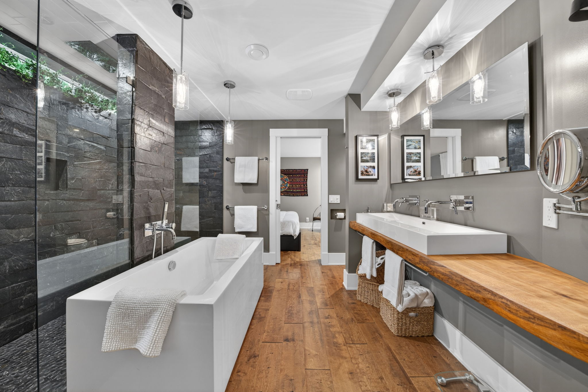 Lower-level bath with a freestanding tub and slate walk-in shower