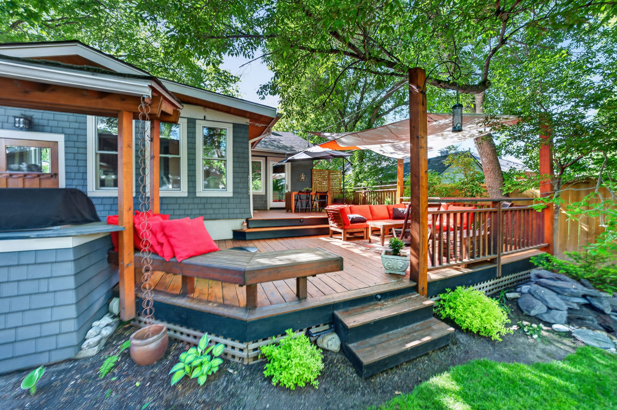 Multi-level cedar deck stepping down to a professionally landscaped lawn