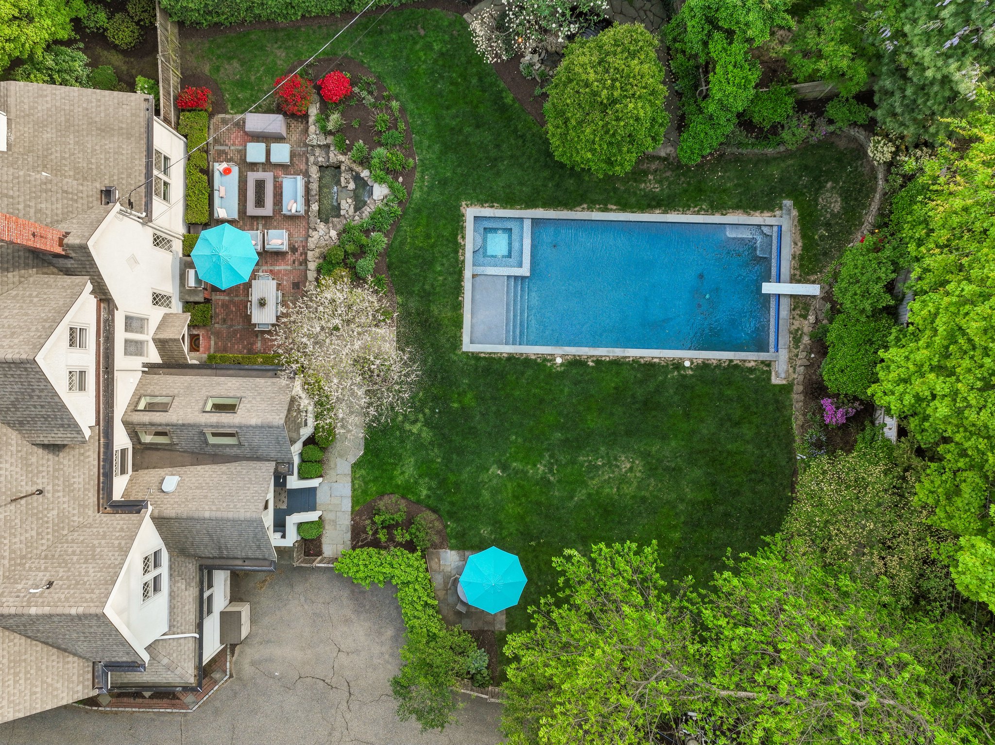 Lovely flat backyard, unusual for Upper Mountain Ave! Waterfall, fish pond and swimming pool right out your back door.