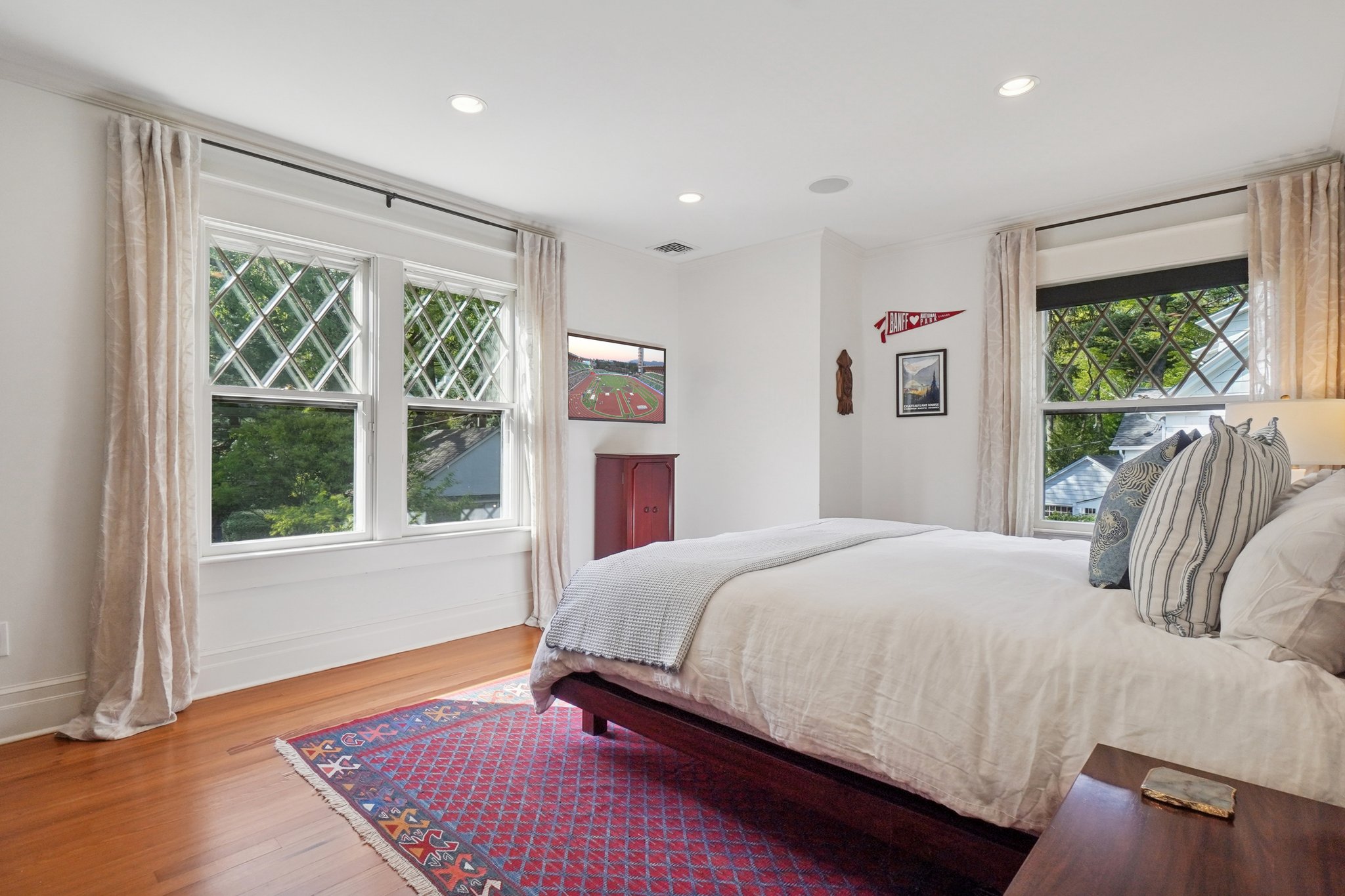 Primary sleeping room. Original Queen Anne diamond-paned windows add timeless character, bathing the interior in beautifully filtered light throughout the house.