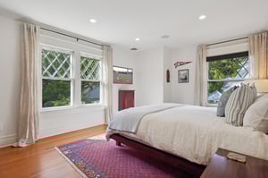 Primary sleeping room. Original Queen Anne diamond-paned windows add timeless character, bathing the interior in beautifully filtered light throughout the house.