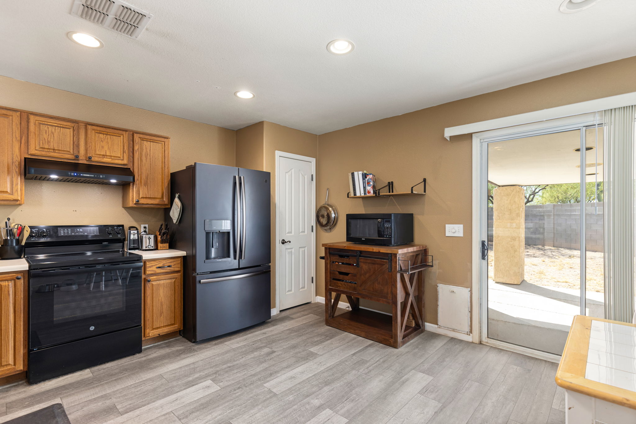 Recessed lighting and a pantry closet. Sliding glass door leading to the spacious backyard.