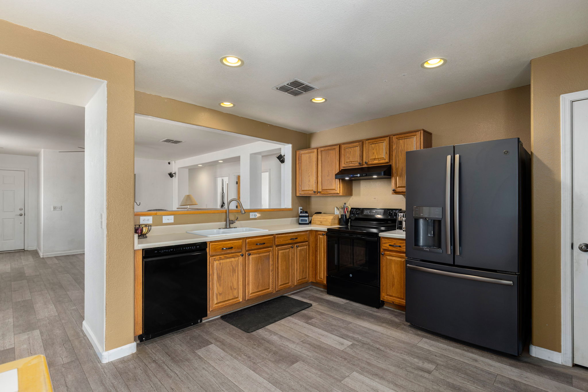 Kitchen with black appliances. Electric range with a gas hookup options behind. *Refrigerator does not convey*