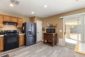 Recessed lighting and a pantry closet. Sliding glass door leading to the spacious backyard.