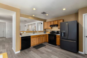 Kitchen with black appliances. Electric range with a gas hookup options behind. *Refrigerator does not convey*