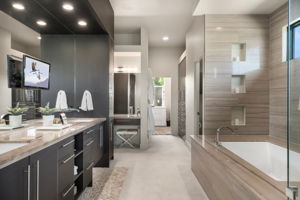 Spa like primary bathroom with 2 walk in closets