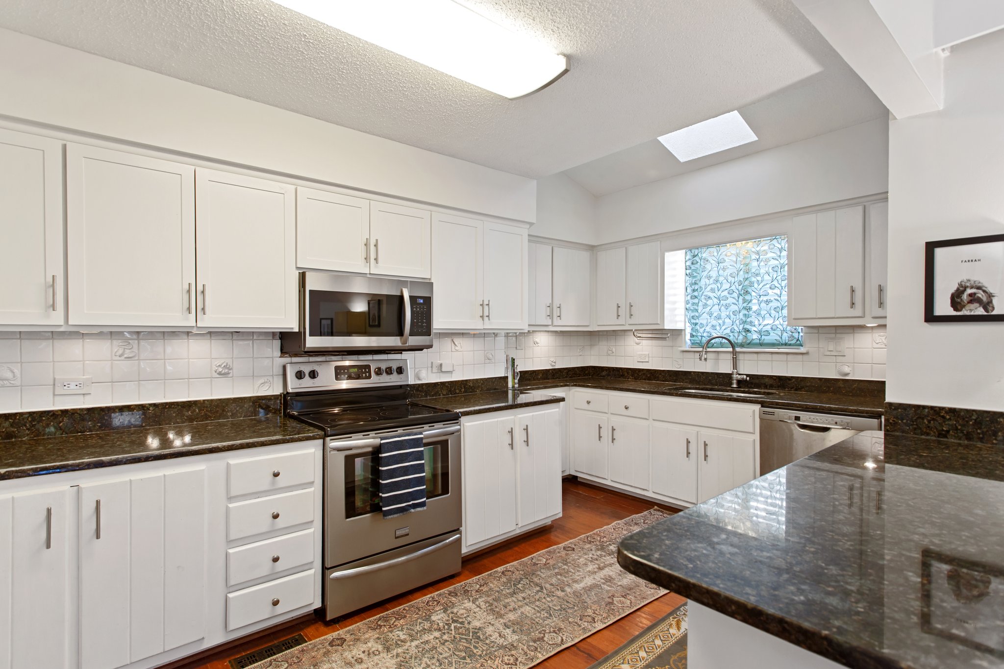 Large open kitchen with ample counter space and wraparound cabinets