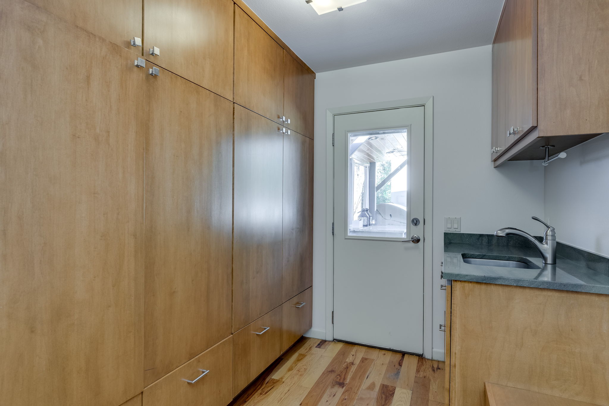 Mudroom with direct access to outdoor kitchen