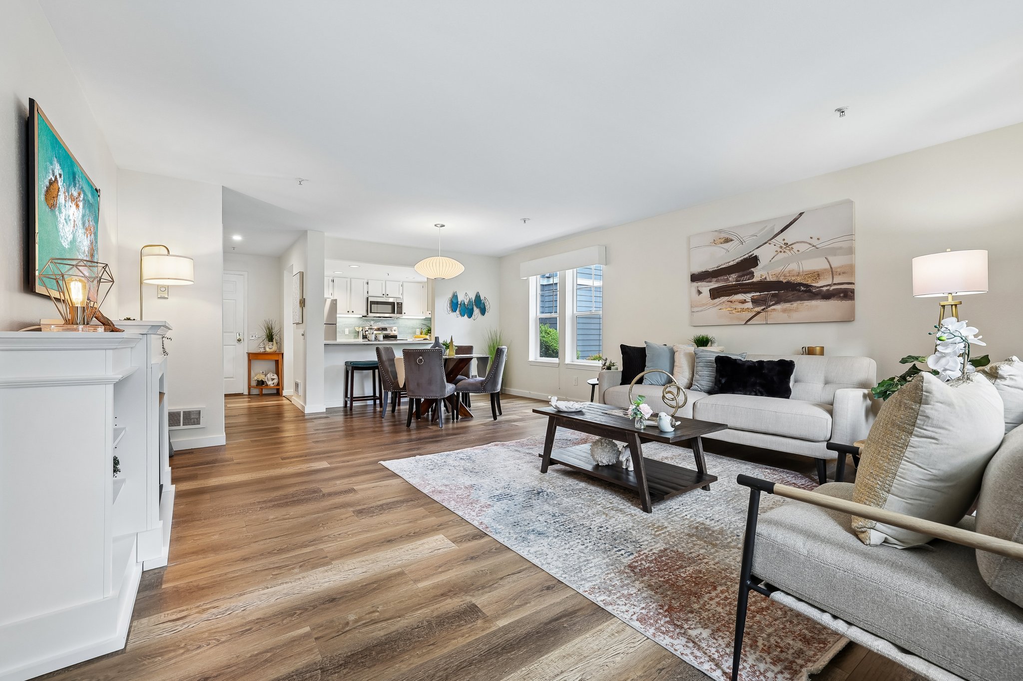 Enter lower level condo with newer windows, plank floors and open spaces