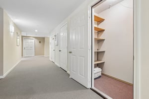 Hallway storage room #111 and front door in distance.