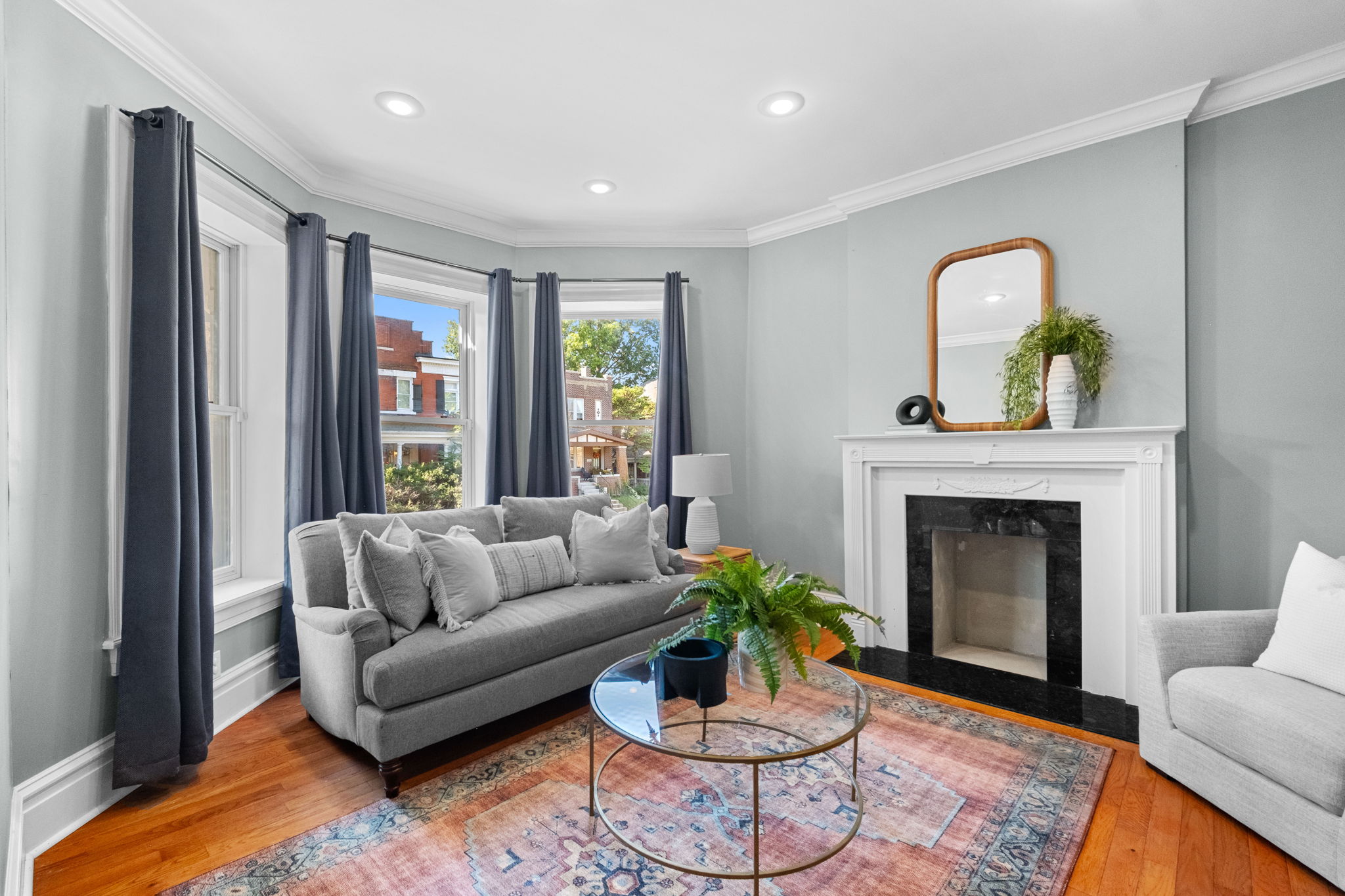 The living room features a lovely bay window, crowned molding, and recessed lighting.