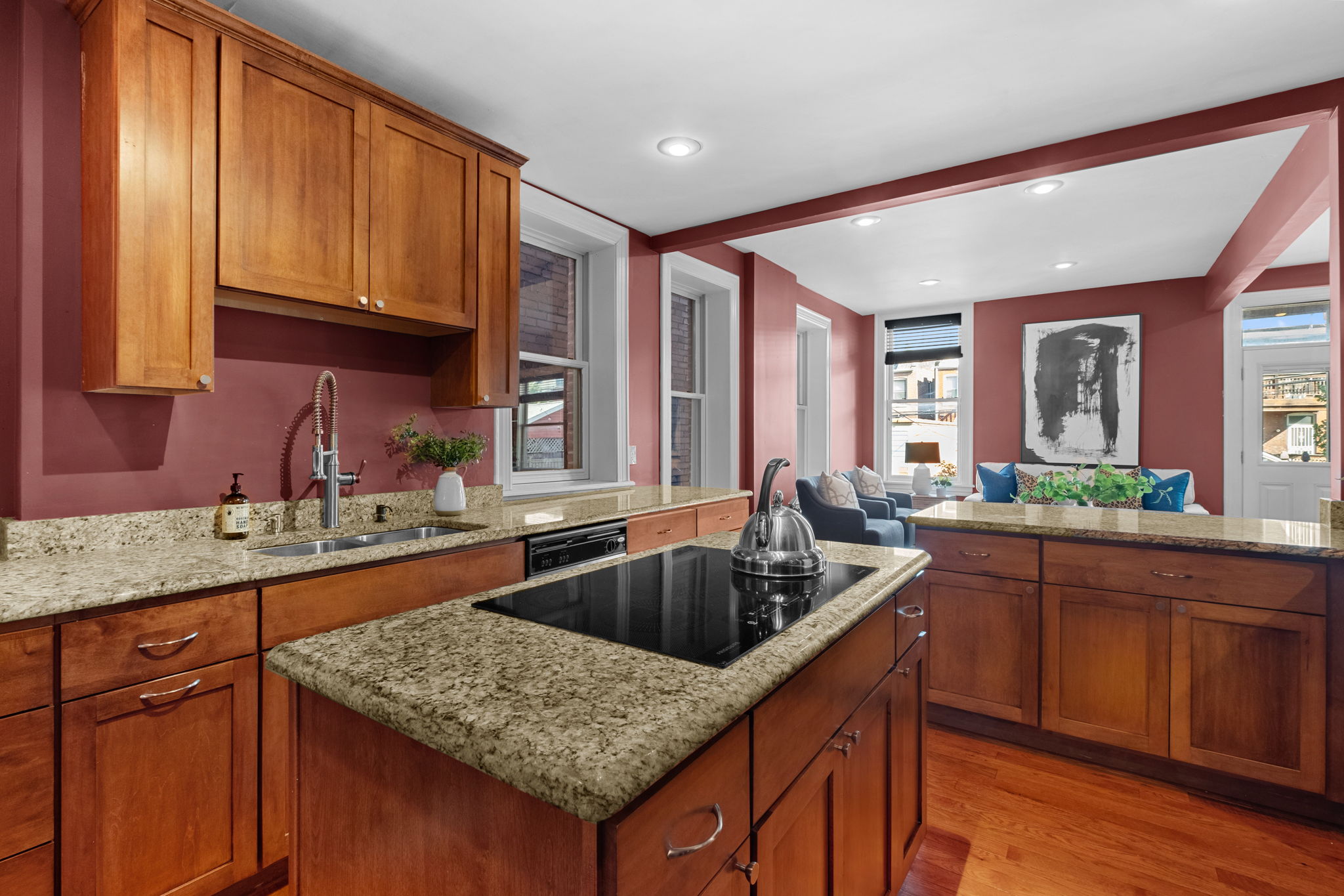 The kitchen has plentiful cabinet space, a center island, and counter seating.