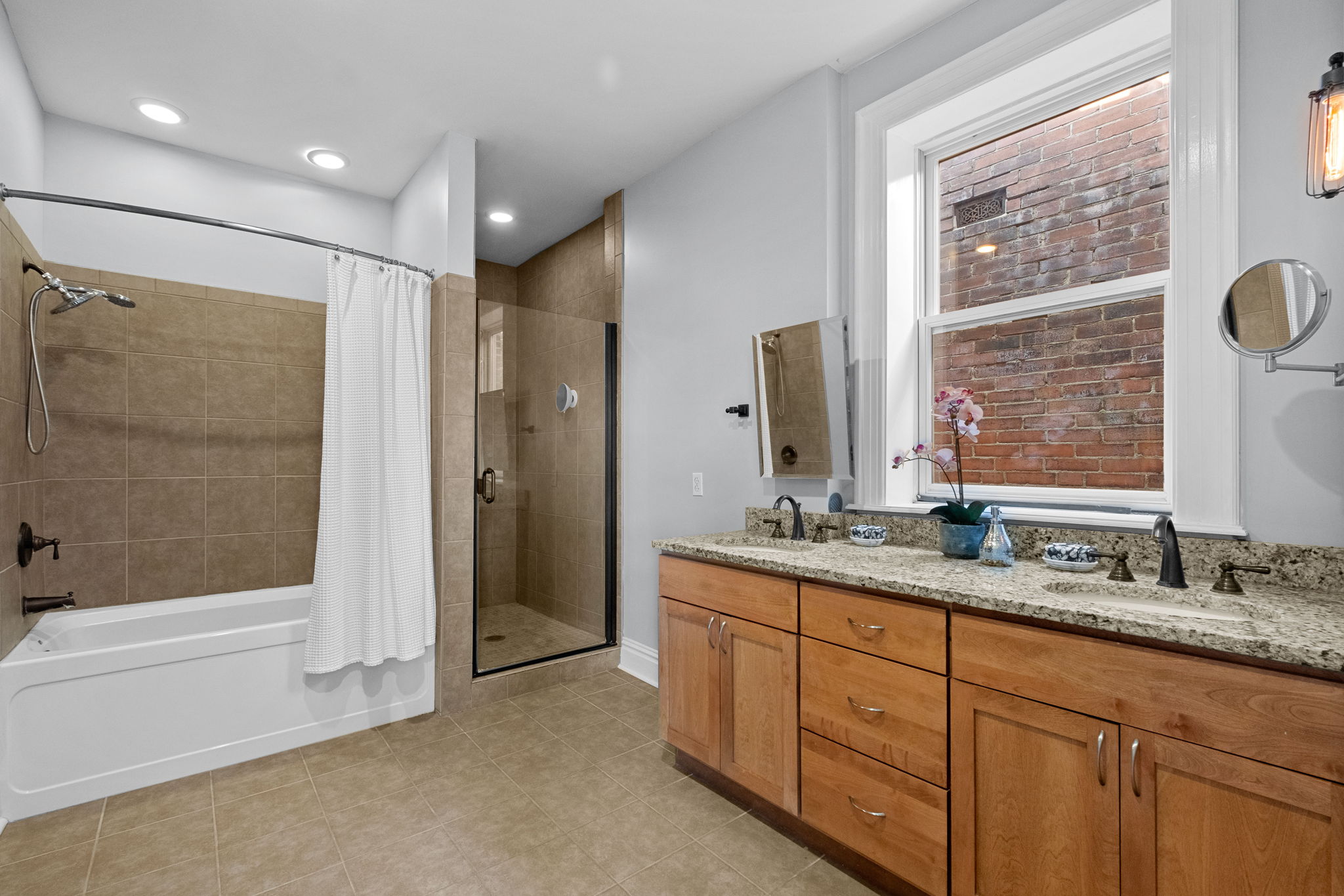 The Primary bath features double sinks, a separate tub and shower, and heated floors.