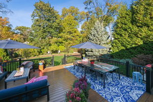 Step through the sliding dining area door to a quiet, private world. An expansive deck and a perennial packed garden framed by mature evergreens.