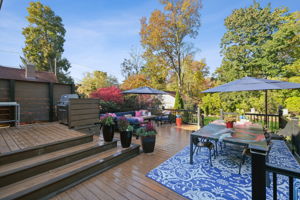 Back upstairs, the expansive deck creates a seamless extension of the interior and a sophisticated expression of mid-century indoor–outdoor living.