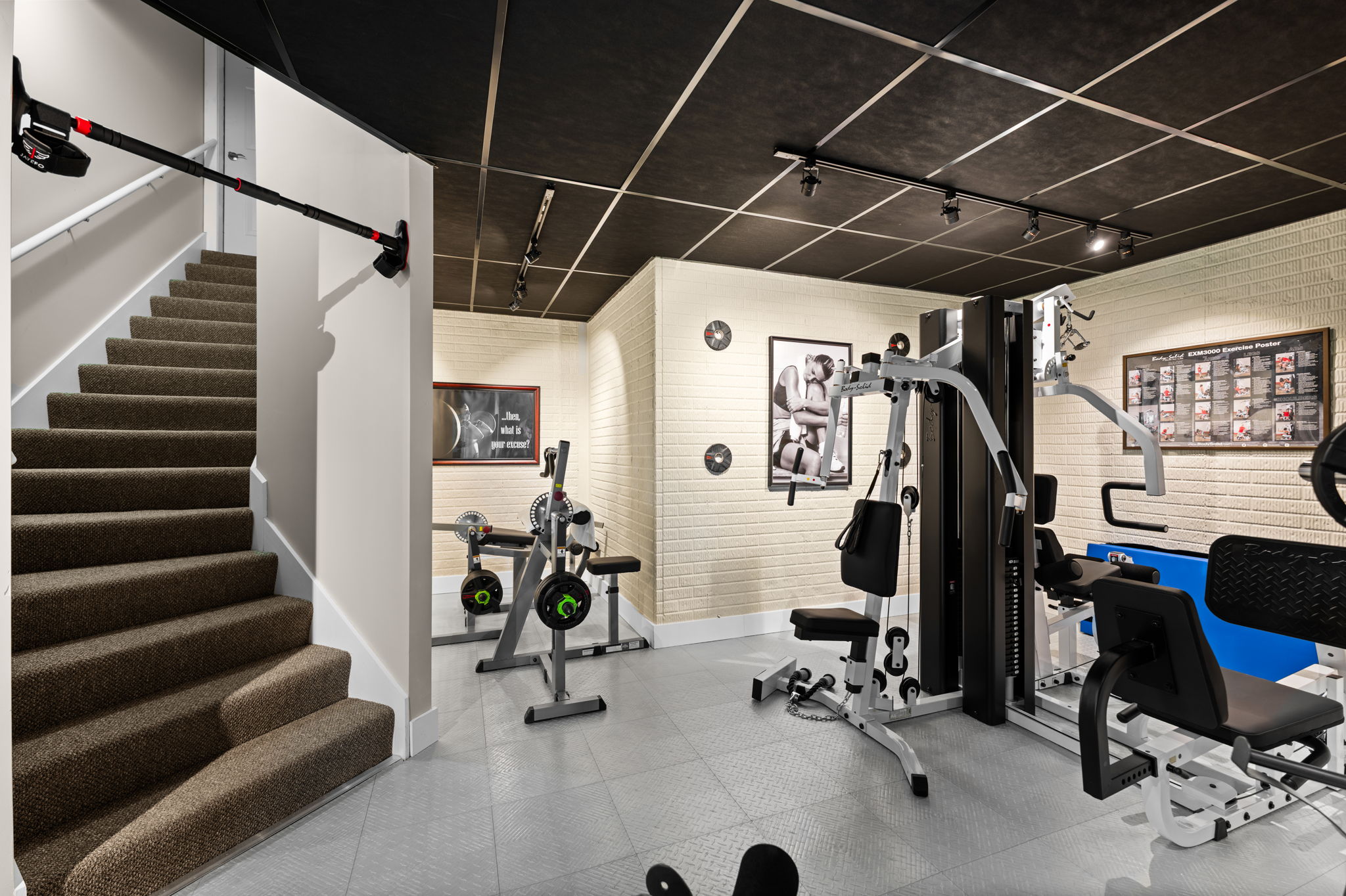 Lower Level Gym with Stairs to Garage