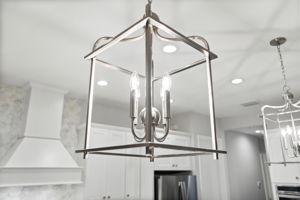 Sleek custom lanterns over island