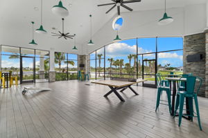 Sscreened in porch with bags and ping pong