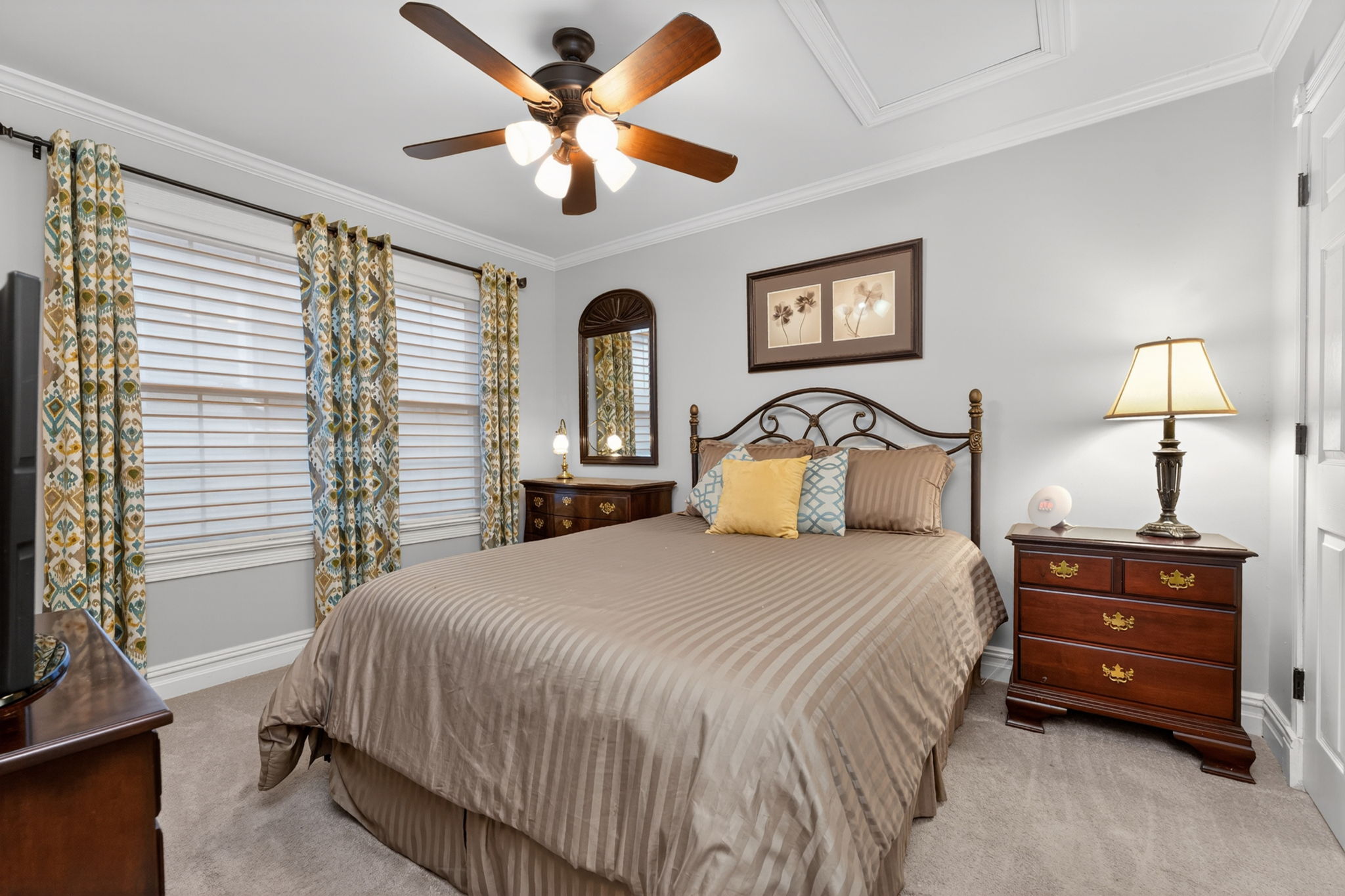 The third bedroom and hall bath offers comfort and privacy for family and overnight guests. Features include crown moulding, ceiling fan, double door closet, and carpeting.