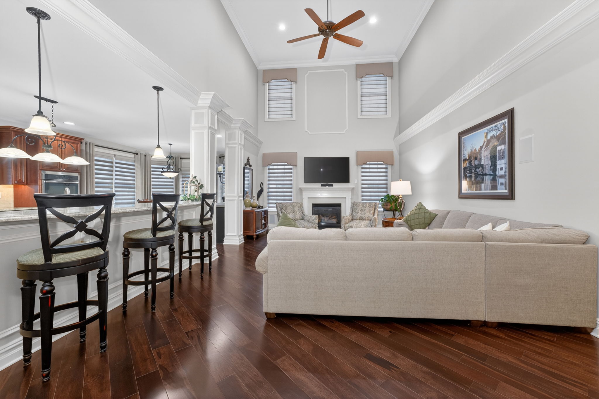 TWO STORY FAMILY ROOM Marble surround fireplaces with custom mantel adds understated sophistication to the dramatic two-story family room. Additional features include recessed lighting, ceiling fan, custom mouldings and wainscoting, 2 story windows.