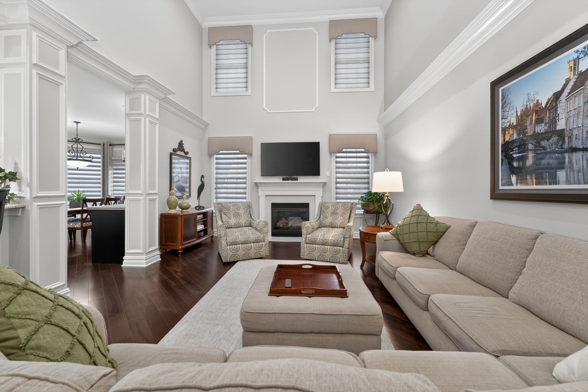 TWO STORY FAMILY ROOM Marble surround fireplaces with custom mantel adds understated sophistication to the dramatic two-story family room. Additional features include recessed lighting, ceiling fan, custom mouldings and wainscoting, 2 story windows.