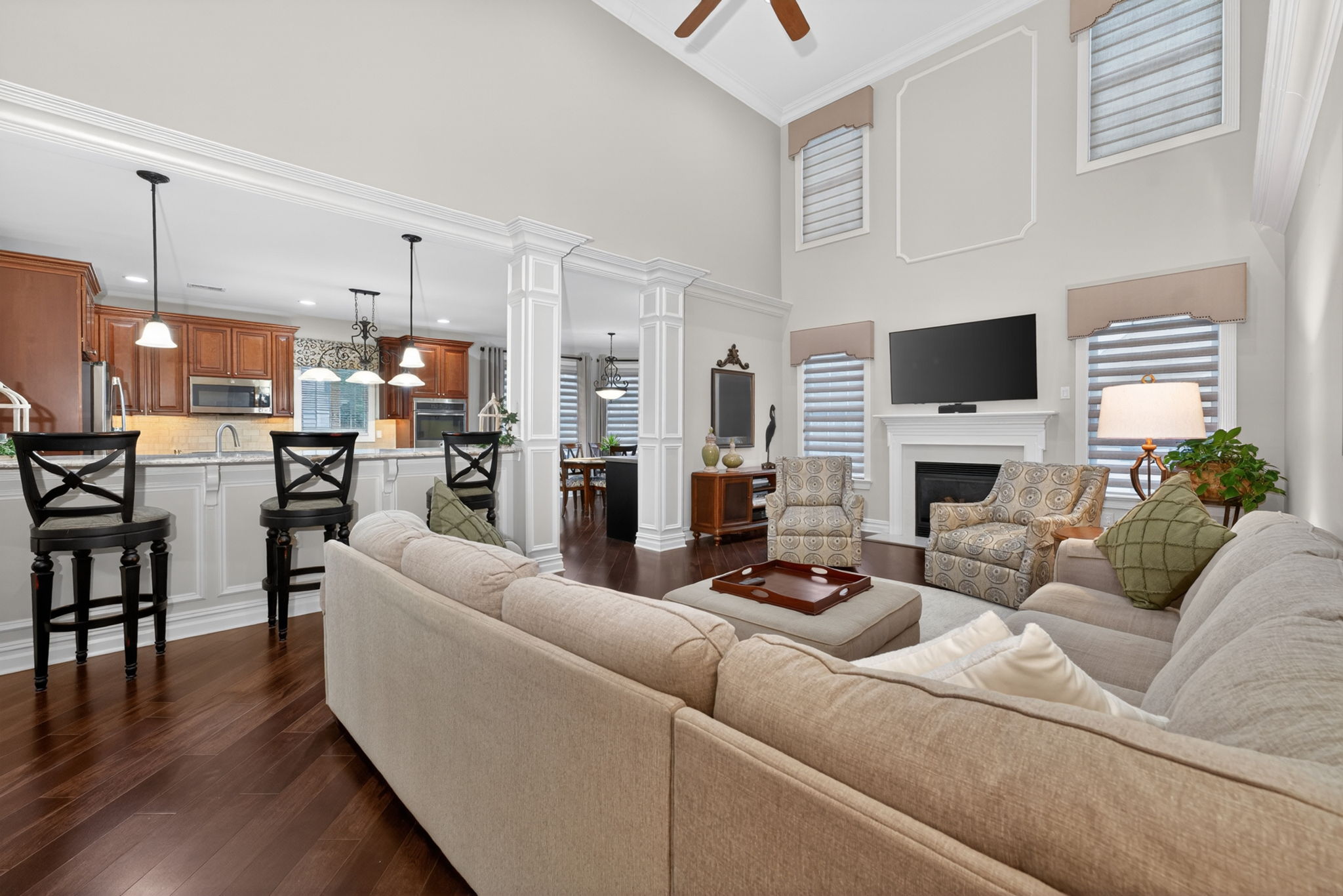 TWO STORY FAMILY ROOM Marble surround fireplaces with custom mantel adds understated sophistication to the dramatic two-story family room. Additional features include recessed lighting, ceiling fan, custom mouldings and wainscoting, 2 story windows.