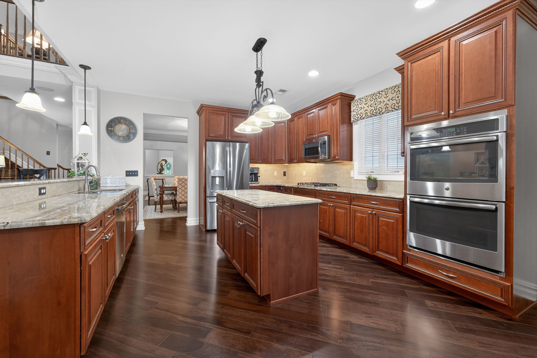The gourmet kitchen is a true culinary workspace, thoughtfully designed with an abundance of beautiful cabinetry, granite countertops, and high-end stainless steel appliances.