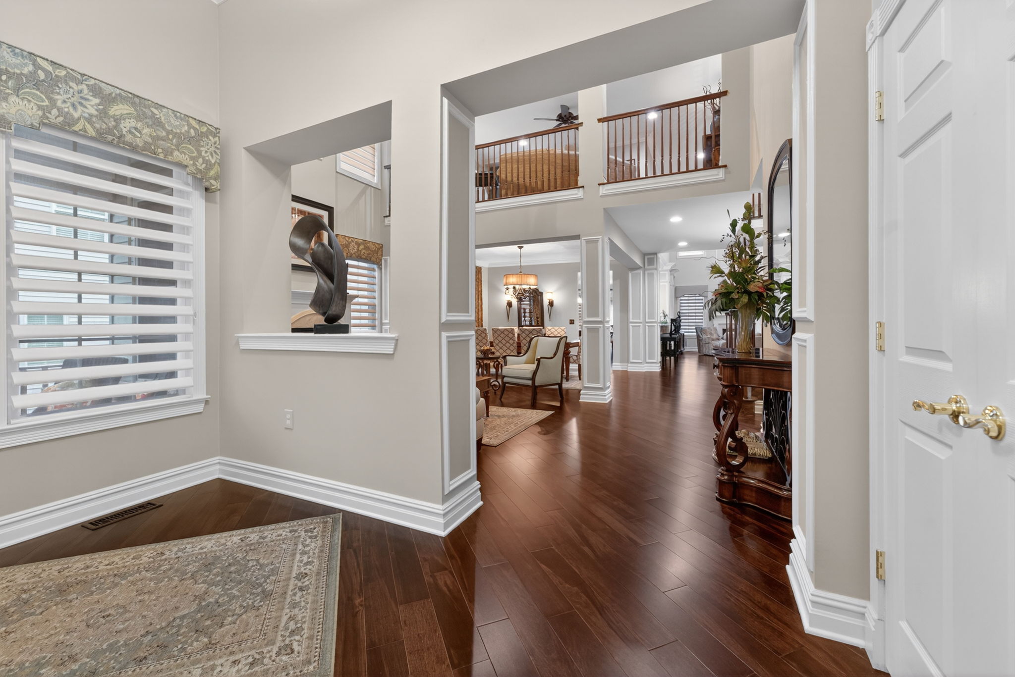 The foyer features a double door closet and hardwood flooring that flows through to the living room, dining room, kitchen, breakfast nook, family room, and study.