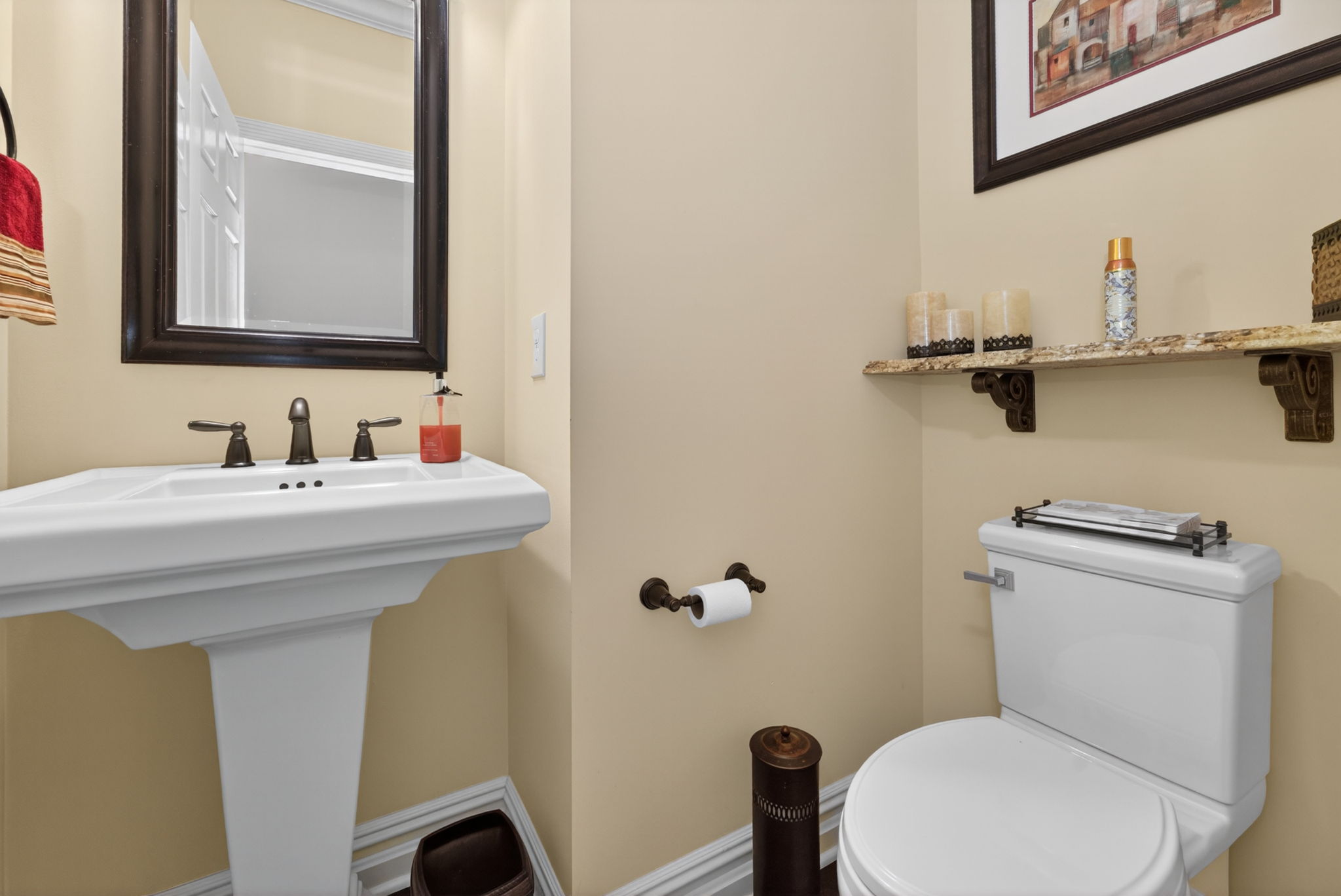 Powder Room Pedestal sink, hardwood flooring.