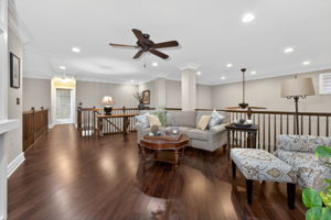 Custom mouldings and built-ins, recessed lighting, ceiling fan, plantation shutters, and hardwood flooring enhance the inviting guest accommodations.