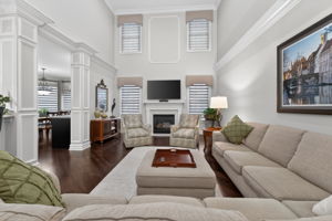 TWO STORY FAMILY ROOM Marble surround fireplaces with custom mantel adds understated sophistication to the dramatic two-story family room. Additional features include recessed lighting, ceiling fan, custom mouldings and wainscoting, 2 story windows.