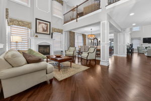 Living Room and Dining Room TWO STORY LIVING ROOM Two story living room features custom mouldings and wainscoting, 2 story windows, a gas fire-place with marble surround and custom mantel.