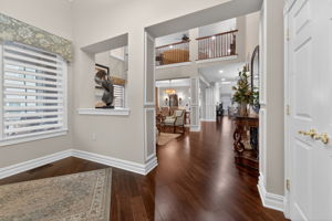The foyer features a double door closet and hardwood flooring that flows through to the living room, dining room, kitchen, breakfast nook, family room, and study.
