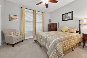 Completing the main level is a second bedroom with its own en suite bath. Additional features include ceiling fan, double door closet and carpeting.