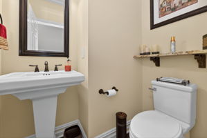 Powder Room Pedestal sink, hardwood flooring.