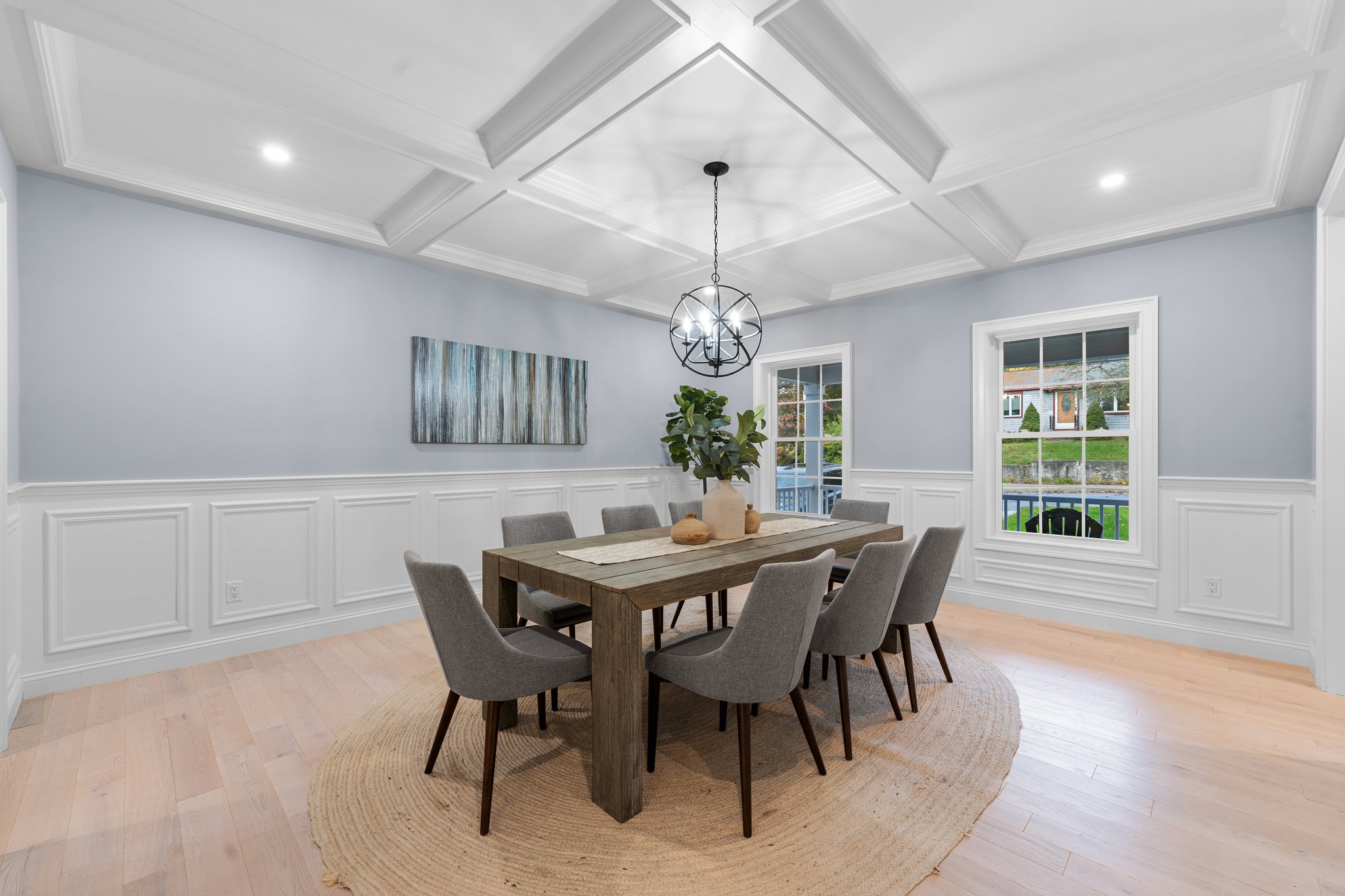 Formal Dining Room with Wainscoting, Coffered Ceiling, Recessed Lights & Decorative Chandelier